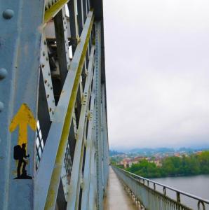 a person standing on a bridge over a river at Fortaleza Faro in Valença