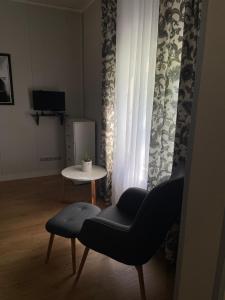 a living room with a chair and a table at Ringi studio in Pärnu