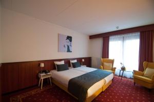 Postel nebo postele na pokoji v ubytování Hotel De Schildkamp
