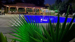 a swimming pool at night with a gazebo at jasmine otel in Kemer +7 photos