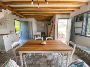 a dining room with a wooden table and chairs at Ληγάτο Cottage House in Áyios Pétros