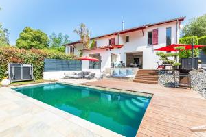 a villa with a swimming pool and a house at Villa Basoa - Villa avec piscine à 10 min plages in Bassussarry