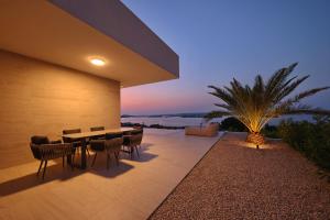 a dining room with a table and chairs on a patio at Cloud 9 D7 in Tkon