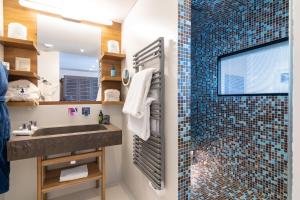 a bathroom with a sink and a shower at Hotel Pashmina Le Refuge in Val Thorens