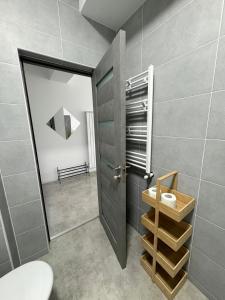 a bathroom with a door and a toilet in a room at Studio 616 SunnyVibes in Mamaia Nord
