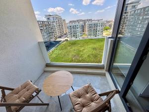 a room with two chairs and a table on a balcony at Studio 616 SunnyVibes in Mamaia Nord