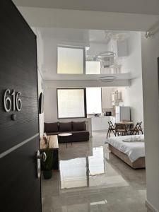a bedroom with a bed and a living room at Studio 616 SunnyVibes in Mamaia Nord +14 photos