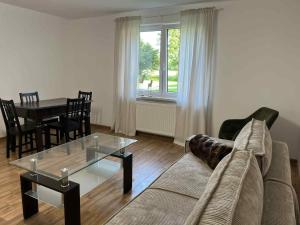 a living room with a couch and a table at Kasztanowy Zakątek in Kolonia Kościelec