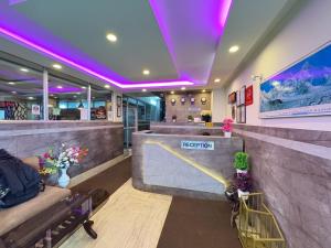 a bar in a restaurant with purple lights at Near Chauk Bazaar Marvel International & Restaurant HD Lama Rd in Darjeeling