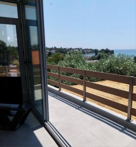 a balcony with a view of the ocean at Summer Project Theros in Nea Kalikratia
