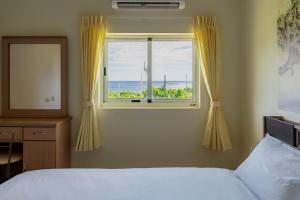 Ένα ή περισσότερα κρεβάτια σε δωμάτιο στο Inapu Ocean View B&B