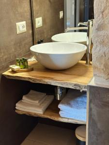 a bathroom with a large white bowl sink on a counter at Masseria Mazzalorsa in Alberobello