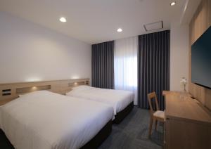 Postel nebo postele na pokoji v ubytování HOTEL NEWITAYA