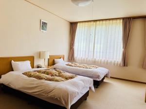 Postel nebo postele na pokoji v ubytování 聖山パノラマホテル + 37 fotografií