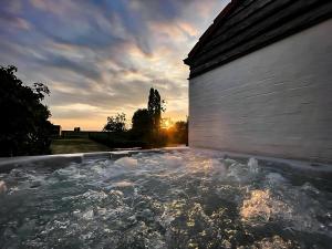 a large pool of water next to a building at Boutique B&B Droomkerke in Ruiselede