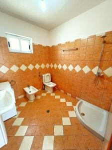 a bathroom with a sink and a toilet and a tub at Green home in Durrës