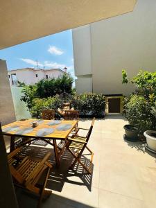 a patio with a table and chairs on a balcony at Villa Agora in Nikiti