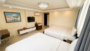 Postel nebo postele na pokoji v ubytování Elite SOFEA Saigon Hotel and Spa