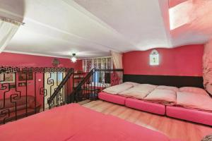 a bedroom with a bed in a room with red walls at Letohrádok in Vlachovo