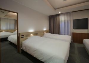 Postel nebo postele na pokoji v ubytování HOTEL NEWITAYA