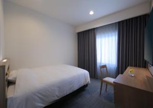 Postel nebo postele na pokoji v ubytování HOTEL NEWITAYA