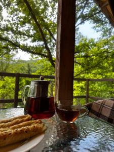a table with a cup of tea and a plate of pizza at AЖ у НЕБІ in Vizhenka