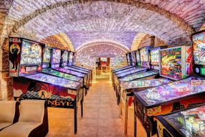 a row of pinball machines in a arcade at Château la hussardiere in Vaîte