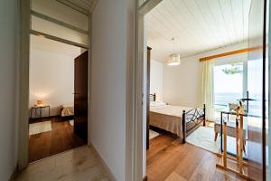 a bedroom with a view of a bed and a window at Apartments Bisko in Prizba