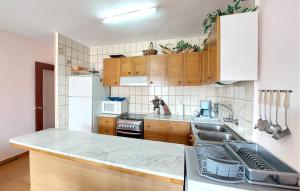 a kitchen with wooden cabinets and a counter top at Euromar Ii in Peñíscola