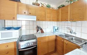 a kitchen with wooden cabinets and a stove and a sink at Euromar Ii in Peñíscola +7 photos