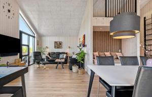 a living room with a table and chairs at Gorgeous Home In Haderslev in Haderslev