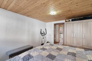 a bedroom with a bed and a wooden ceiling at Ferienwohnung Hagen in Pfalzgrafenweiler
