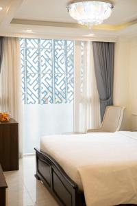 Postel nebo postele na pokoji v ubytování Elite SOFEA Saigon Hotel and Spa