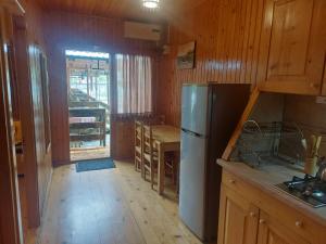 a kitchen with a refrigerator and a table in it at Dreamy Hotel in Ureki