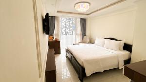 Postel nebo postele na pokoji v ubytování Elite SOFEA Saigon Hotel and Spa