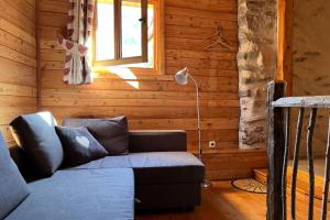 a living room with a couch and a window at Au Vialaou - Chez Marcelle in Névache +2 photos