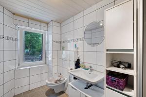 a white bathroom with a sink and a toilet at Ferienwohnung Hagen in Pfalzgrafenweiler