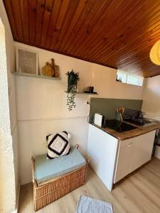 a small kitchen with a counter and a refrigerator at Studio Bougainvillier in La Seyne-sur-Mer +2 photos