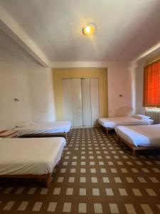 a room with four beds and a window at Campus Santa Maria in Cannes