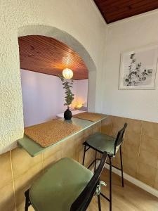 a room with a table and a chair and a mirror at Studio Bougainvillier in La Seyne-sur-Mer