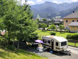 an rv parked in a parking lot next to a tree at Tiny Anna's Cozy Home near Redbull Ring in Liesingthal