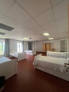 a large room with three beds in it at Campus Santa Maria in Cannes +9 photos