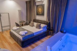 a bedroom with a bed and a bath tub at Four Luxury Suite in Palermo
