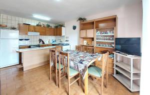 a kitchen with a table and chairs and a television at Euromar Ii in Peñíscola