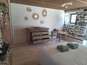a bedroom with a bed and a wooden floor at Lou Montadou in Yssingeaux