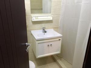 a bathroom with a white sink and a mirror at Hotel Prestige Struga in Struga