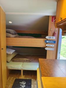 a bunk room with two bunk beds in it at Tiny Anna's Cozy Home near Redbull Ring in Liesingthal