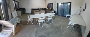 a room with a table and chairs in a kitchen at La FRANCESCA in Reconquista