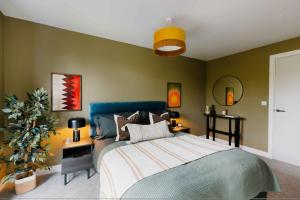a bedroom with a bed and a green wall at Charles Hope Birmingham Westside in Birmingham