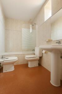 un baño con inodoro y lavabo en Pension Gelin, en Carrizo de la Ribera